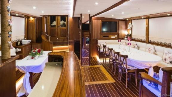 The stylishly furnished interior of the gulet S-Nur Taylan with a spacious dining area and cosy seating areas.